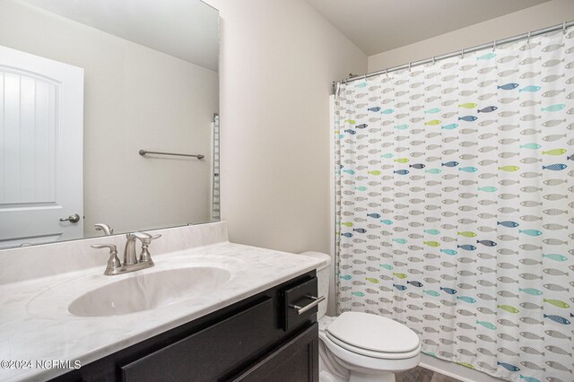 bathroom with vanity, toilet, and a shower with curtain