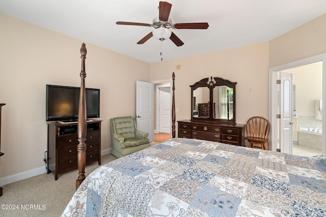 carpeted bedroom with ensuite bath and ceiling fan