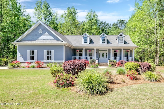 227 October Glory Dr, Wallace, NC 28466 - cape cod house featuring a porch, a front yard, and a shingled roof