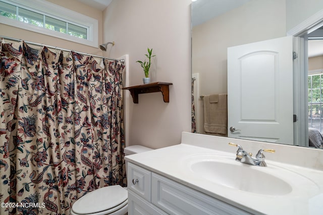 bathroom with a shower with curtain, vanity, and toilet