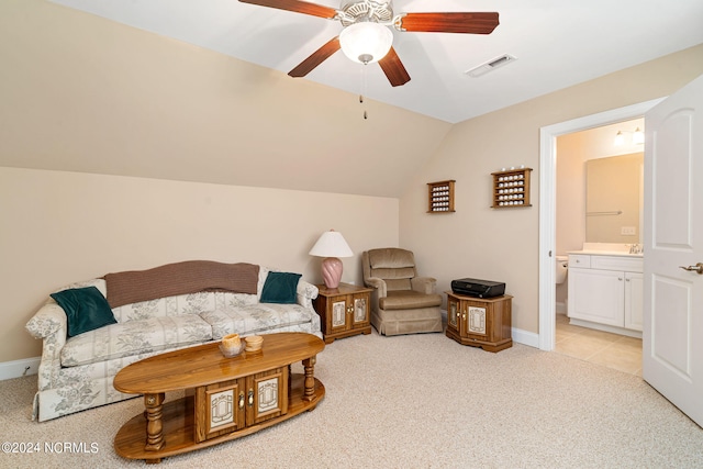 living room with ceiling fan, lofted ceiling, and light carpet