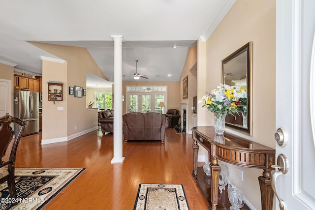 living room featuring lofted ceiling, ceiling fan, wood-type flooring, and ornate columns