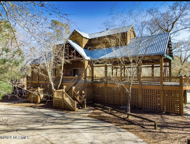 227 October Glory Dr, Wallace, NC 28466 - view of front facade with a porch, metal roof, and stairs