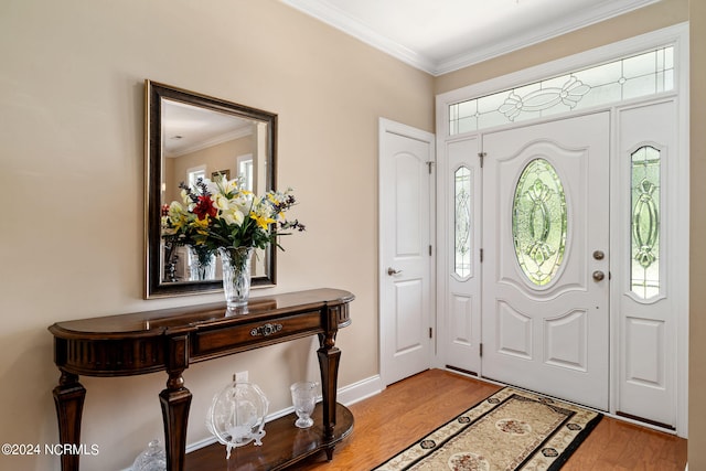 foyer with wood-type flooring and crown molding