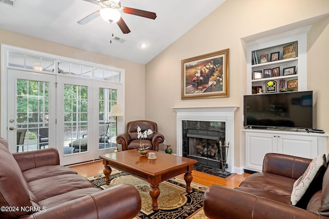 227 October Glory Dr, Wallace, NC 28466 - living area with lofted ceiling, light wood-style flooring, a fireplace, ceiling fan, and french doors
