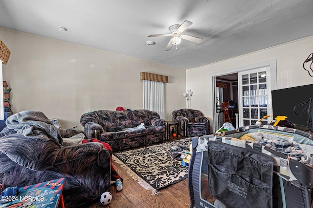 living room featuring hardwood / wood-style floors and ceiling fan