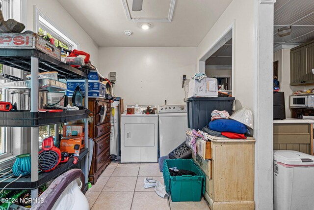 washroom featuring separate washer and dryer and light tile floors