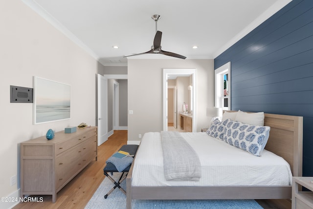 bedroom with crown molding, ceiling fan, light hardwood / wood-style flooring, and ensuite bathroom