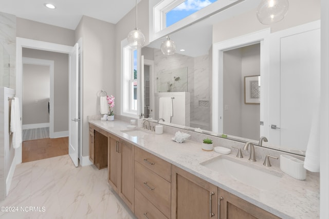 bathroom with vanity and tiled shower