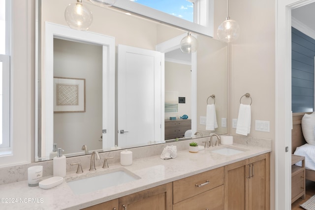 bathroom featuring crown molding and vanity