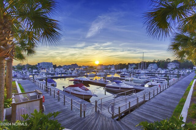 dock area with a yard and a water view