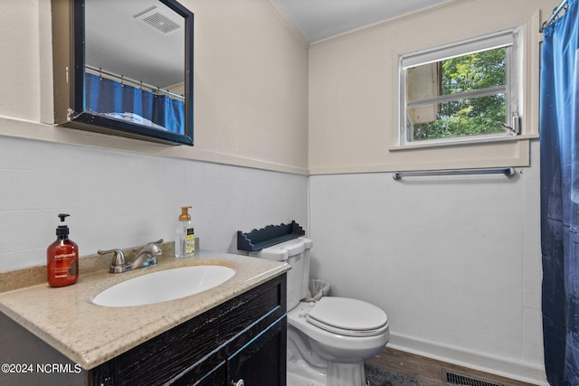 bathroom with hardwood / wood-style flooring, tile walls, tasteful backsplash, vanity, and toilet