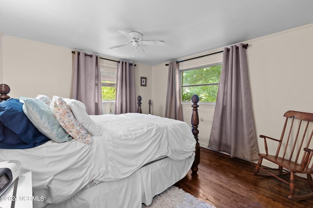 bedroom with dark hardwood / wood-style flooring and ceiling fan