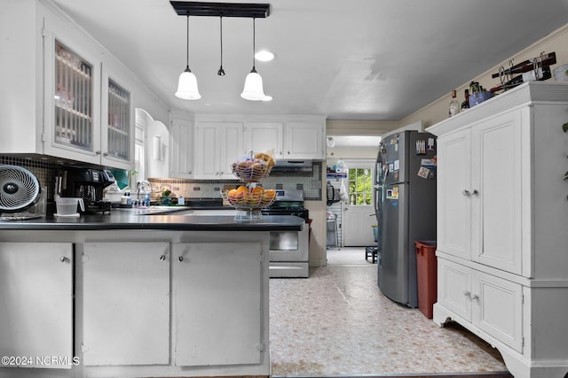 kitchen featuring white cabinetry, kitchen peninsula, backsplash, black refrigerator, and sink