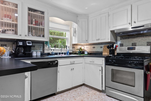 kitchen featuring appliances with stainless steel finishes, white cabinetry, sink, and backsplash