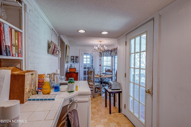 interior space with crown molding, recessed lighting, a notable chandelier, and a textured ceiling
