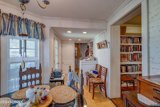 dining area with ornamental molding and a textured ceiling