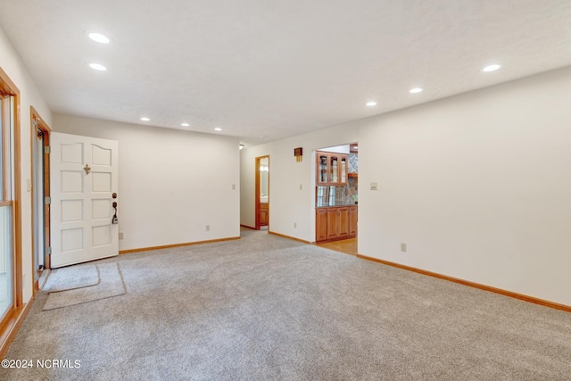 spare room featuring light colored carpet