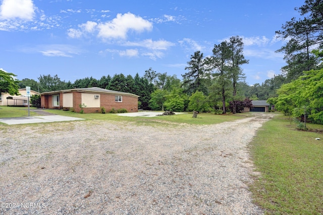 view of front of property featuring a garage and a front lawn