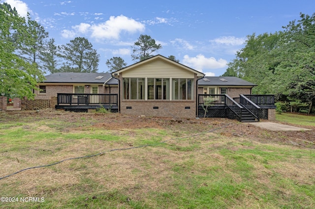 back of house with a sunroom and a deck