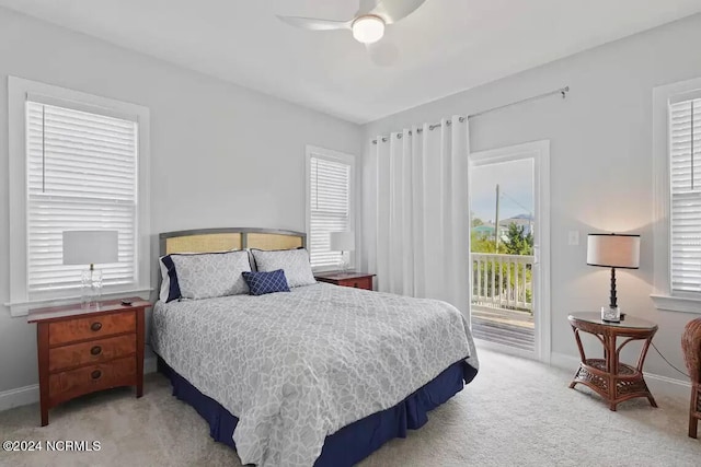 carpeted bedroom featuring access to exterior, ceiling fan, and multiple windows