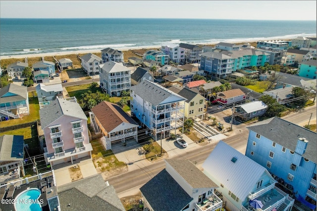 birds eye view of property with a water view and a view of the beach