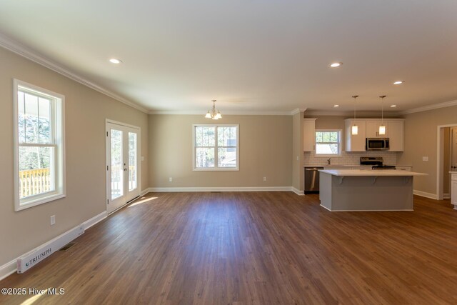 kitchen featuring a center island, dark hardwood / wood-style flooring, pendant lighting, and white cabinets