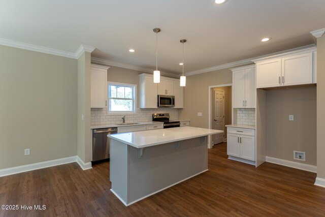 kitchen with white cabinets, sink, dark hardwood / wood-style floors, decorative backsplash, and decorative light fixtures