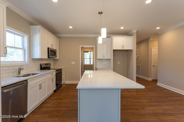 kitchen featuring white cabinets, dark hardwood / wood-style flooring, decorative light fixtures, and a kitchen island