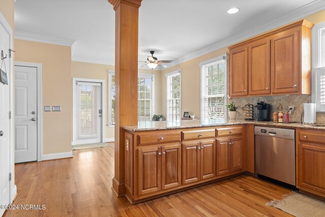 kitchen with ornamental molding, brown cabinets, a peninsula, and stainless steel dishwasher