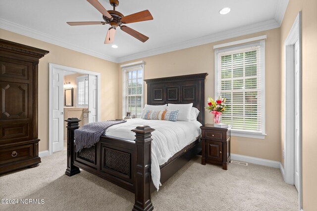 bedroom with baseboards, crown molding, and light colored carpet