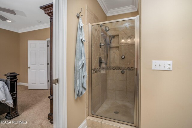 full bath with ceiling fan, ornamental molding, a shower stall, and baseboards