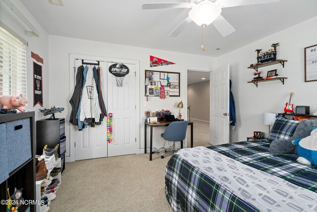 bedroom with light carpet, ceiling fan, and a closet