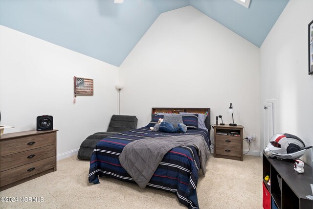 bedroom with high vaulted ceiling, carpet, and baseboards