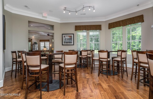 dining room featuring ornamental molding, wood finished floors, and visible vents