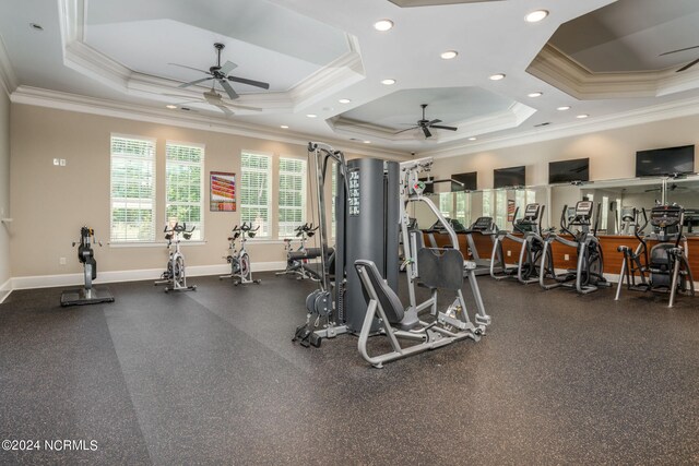 exercise room with recessed lighting, a raised ceiling, crown molding, and baseboards