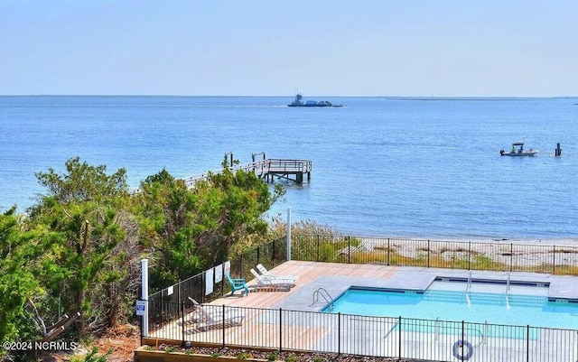 view of swimming pool featuring a water view