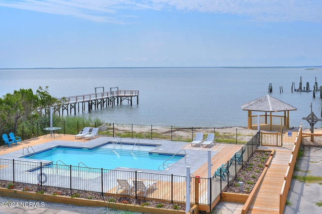 view of swimming pool featuring a water view and a gazebo