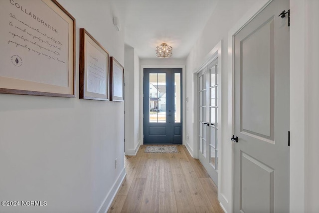 entryway with french doors and light hardwood / wood-style flooring