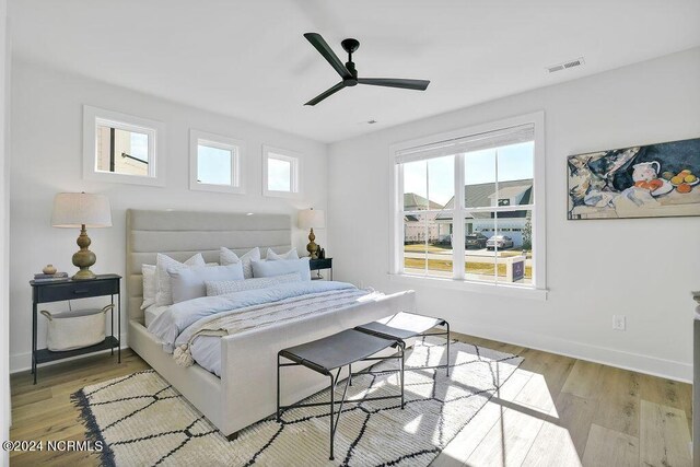 bedroom with ceiling fan and light hardwood / wood-style floors