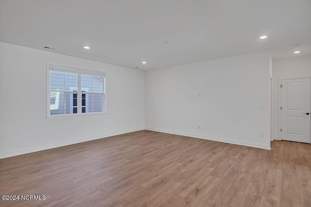 spare room featuring light hardwood / wood-style floors