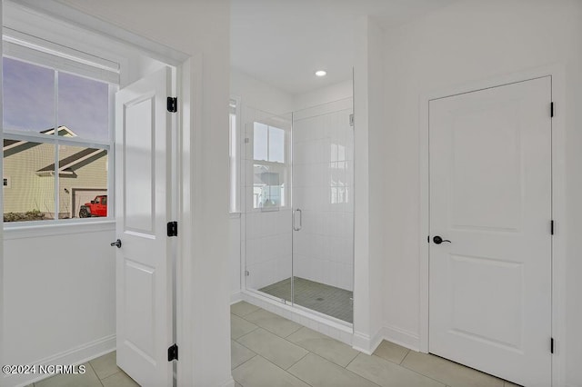 bathroom featuring tile patterned flooring and a shower with shower door