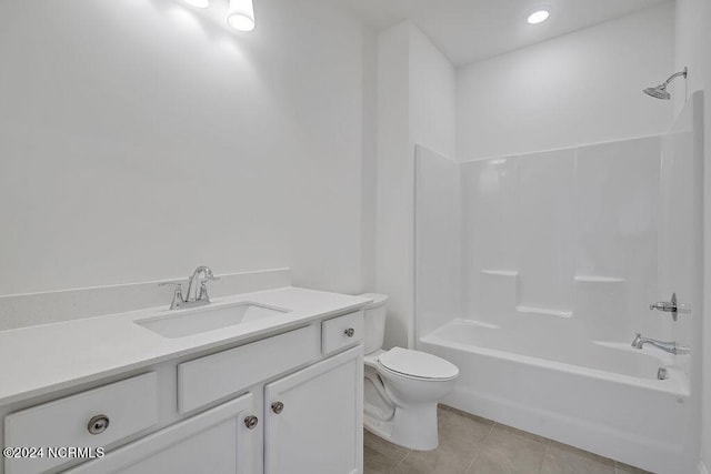 full bathroom with tub / shower combination, vanity, tile patterned floors, and toilet