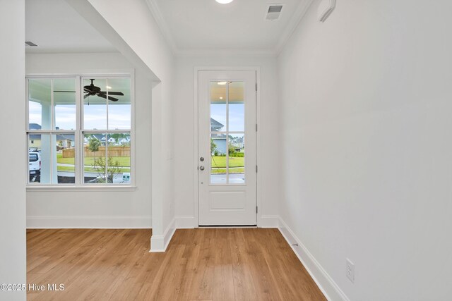 1320 Trisail Ter, Wilmington, NC 28412 - doorway featuring light wood-style floors, baseboards, ornamental molding, and visible vents