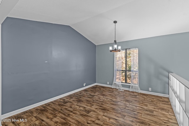 unfurnished dining area featuring hardwood / wood-style flooring, vaulted ceiling, and a chandelier