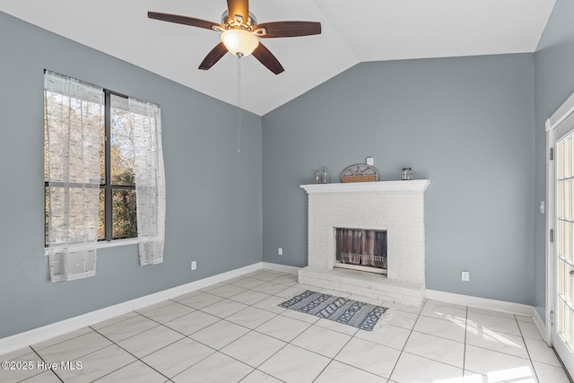 unfurnished living room with lofted ceiling, a brick fireplace, a wealth of natural light, and ceiling fan