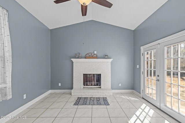 unfurnished living room with light tile patterned flooring, a fireplace, vaulted ceiling, and a wealth of natural light