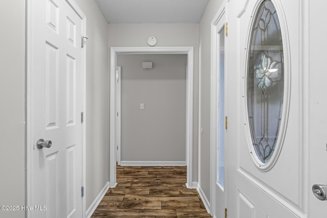 corridor with dark hardwood / wood-style floors