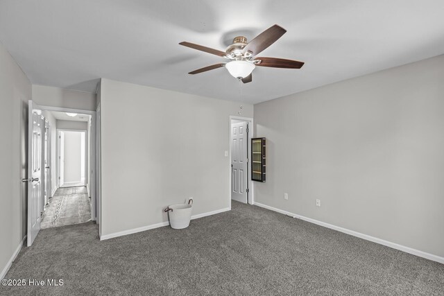 carpeted empty room featuring ceiling fan