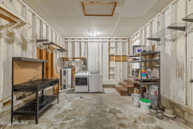 basement featuring water heater and washing machine and dryer